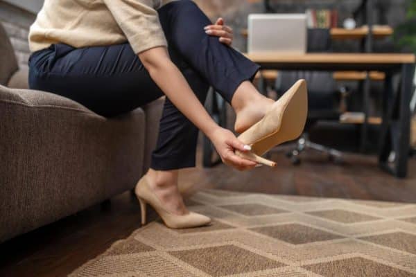 female-pulling-off-stylish-highheeled-shoes-rug